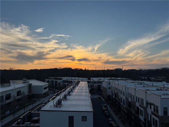 Panoramic view of residential buildings and a scenic sunset sky.