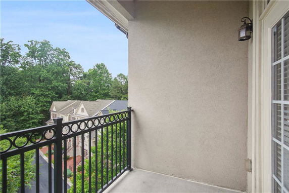 View from a balcony overlooking houses and trees