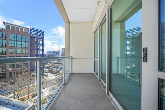 View from a balcony overlooking nearby buildings and surroundings.