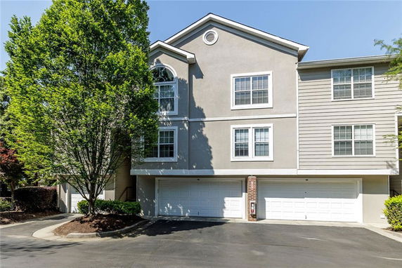 Front view of a residential building with multiple garages.