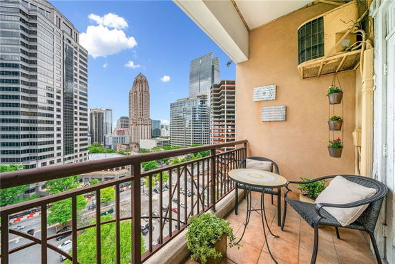 Balcony view showing high-rise buildings in a cityscape.