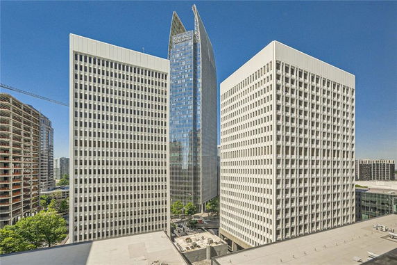 Front view of three tall office buildings in an urban setting.