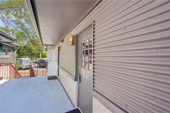 Side view of a building entrance with a door numbered 24.