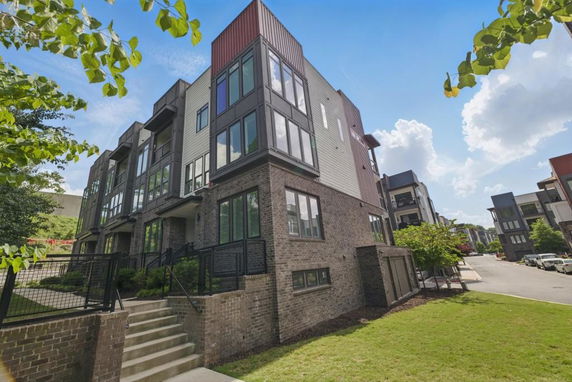 Front view of a modern multi-story brick building.