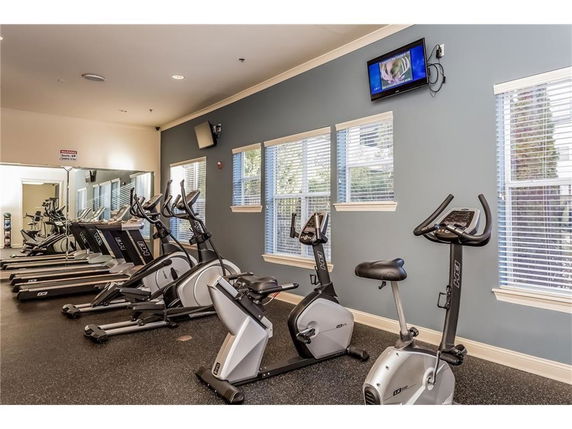 Indoor gym area with exercise bikes and treadmills.