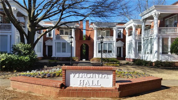 Front view of a building labeled Virginia Hall, featuring brick walls and white columns.