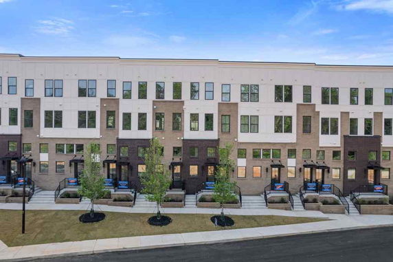 Front view of a multi-story residential building with individual entrances.