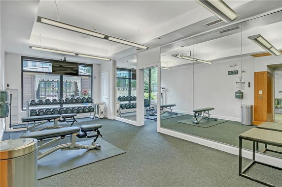Indoor gym area with weights and benches.