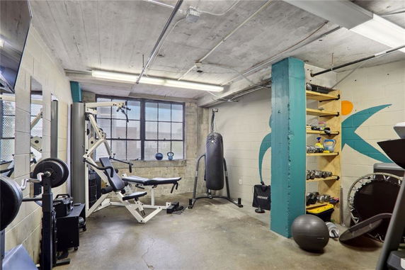 Indoor gym area with fitness equipment including a weight machine, punching bag, and dumbbells.