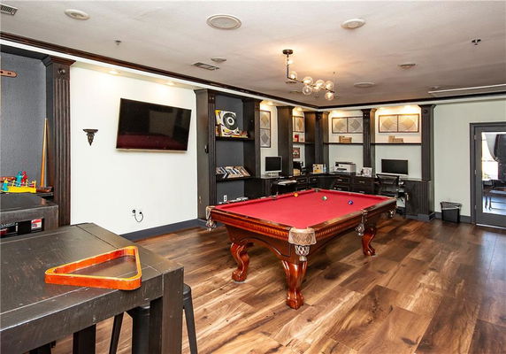 Indoor room with a pool table and computer stations.