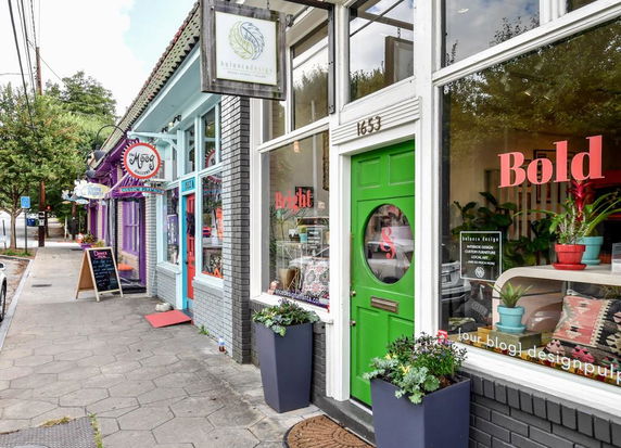 Front view of a colorful commercial building with multiple storefronts.