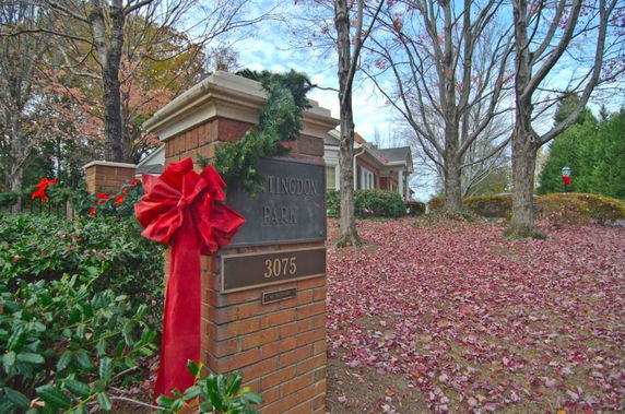 Front view of a house with brick structures and a decorative ribbon.