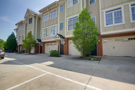 Front view of a multi-story residential building with garages.