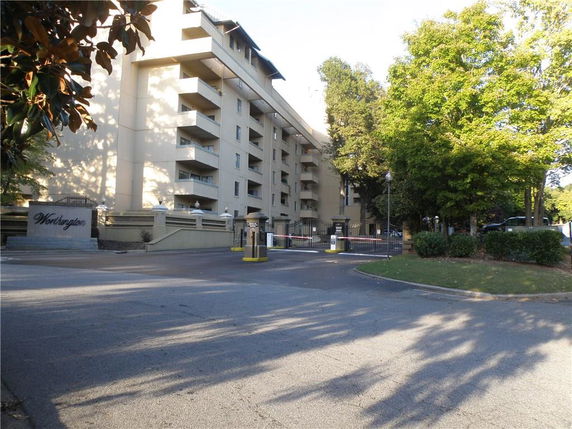 Front view of a multi-story residential building with balconies.