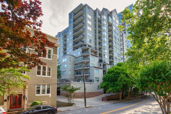 Front view of a multi-story residential building with balconies.