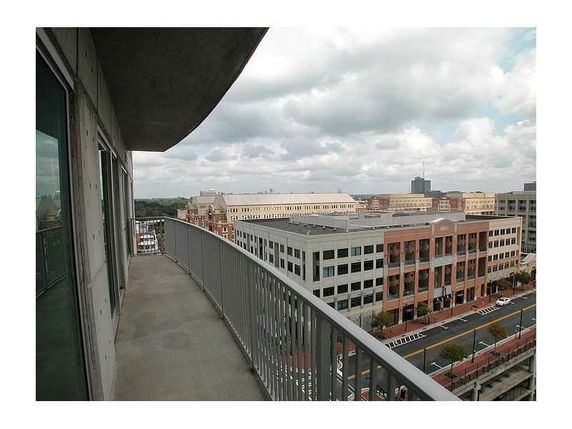 Balcony view overlooking adjacent buildings and street.