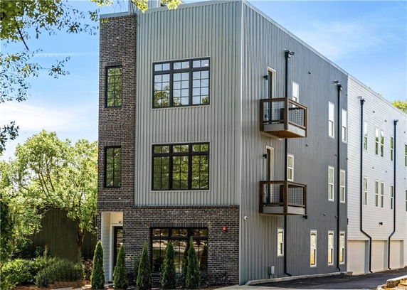 Front view of a multi-story building with brick and metal facade.