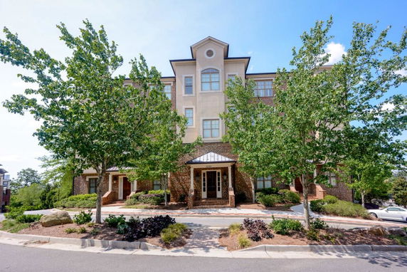 Front view of a multi-story building with brick and stucco facade.