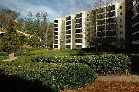 Front view of a multi-story building complex with large windows.