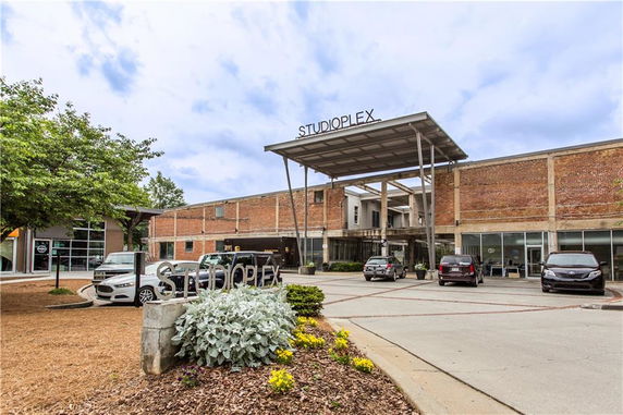 Front view of a building with a modern industrial design and a canopy entrance.