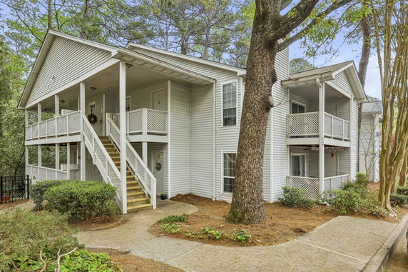 Front view of a two-story building with exterior stairs and balconies.