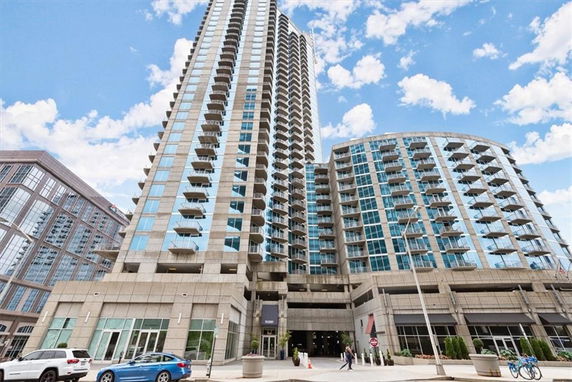 Front view of a modern high-rise building with glass balconies.