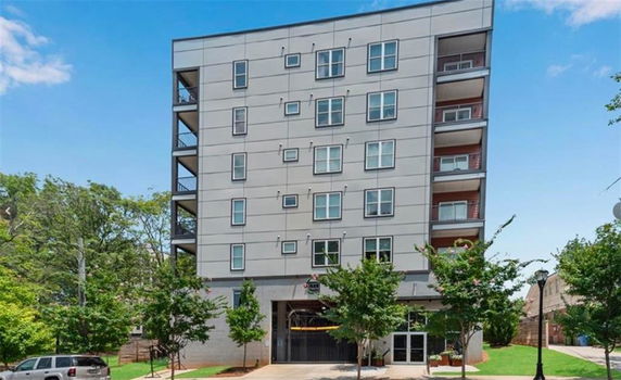 Front view of a multi-story residential building with balconies.