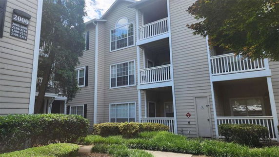 Front view of a multi-story residential building with balconies.