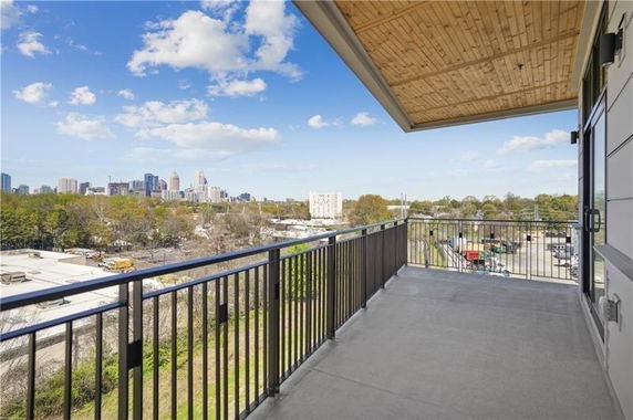Elevated view showcasing city skyline and surrounding area from a balcony.