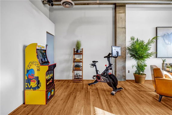 Indoor area with an arcade machine and exercise bike.