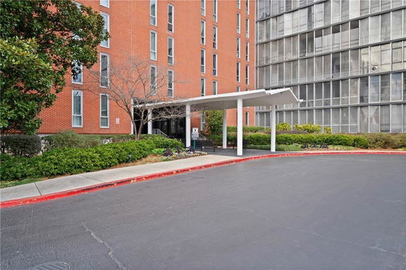 Front view of a multi-story building with a sheltered entrance.