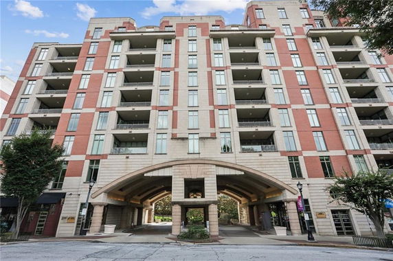 Front view of a multi-story residential building with balconies.
