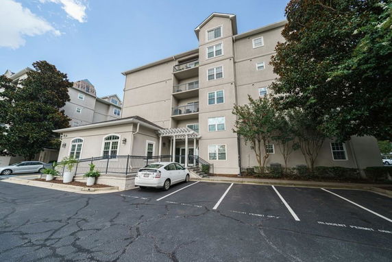 Front view of a multi-story residential building with balconies.