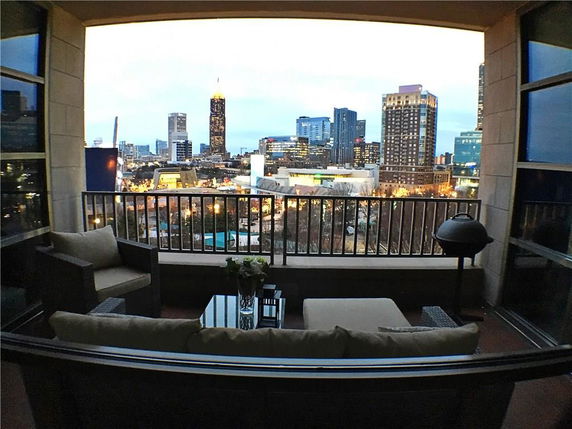 Balcony view overlooking city skyline with skyscrapers.