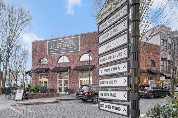 Front view of a brick commercial building with large windows.