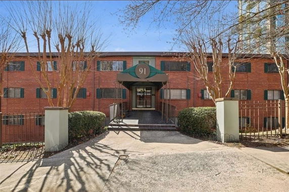Front view of a multi-story brick building with a central entrance.
