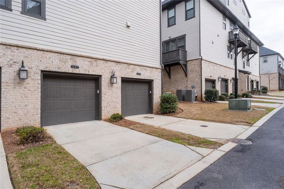 Front view of a multi-story townhouse with multiple garages.