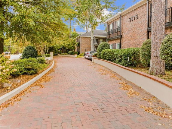 Front view of a two-story brick building with balconies.