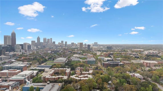 Panoramic view of a cityscape with high-rise buildings and greenery.