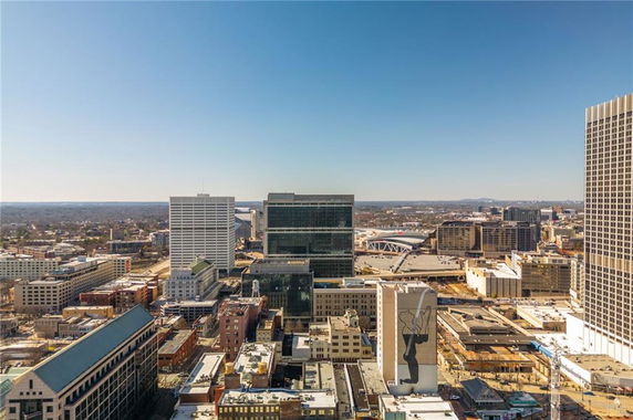 Aerial view of downtown cityscape with numerous buildings and skyscrapers.