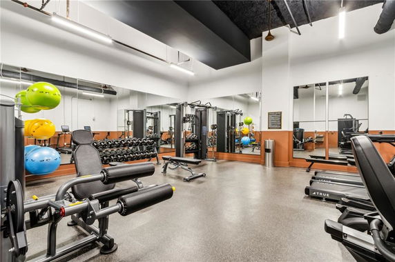 Indoor gym area with exercise equipment and mirrors.