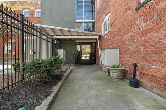 Front view of a brick building entrance with a covered walkway.
