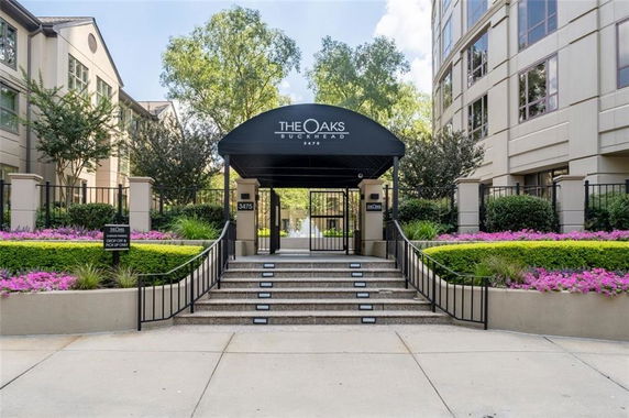 Front view of a building entrance with steps and a canopy.
