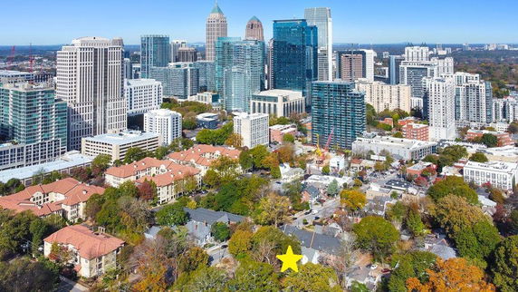 Aerial view of a cityscape with a mix of skyscrapers and residential buildings.