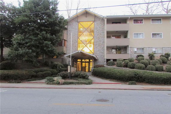 Front view of a multi-story apartment building with a prominent entrance.