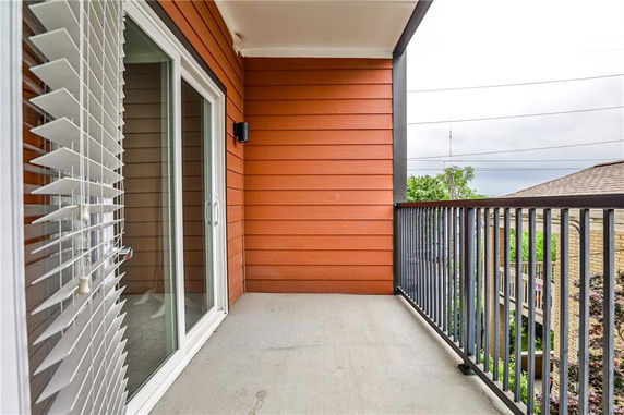 Balcony view with railing and sliding glass door.