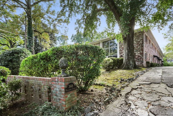 Front view of a two-story brick building with a driveway.