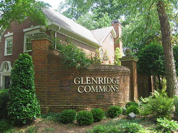 Front view of a brick residential building with Glenridge Commons signage.