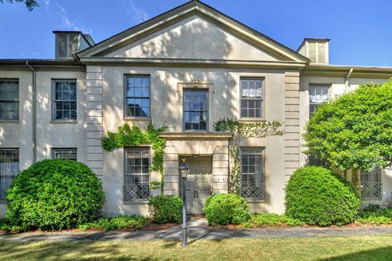 Front view of a two-story house with classical architectural elements.