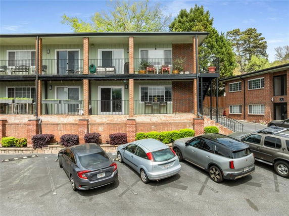 Front view of a two-story apartment building with balconies.